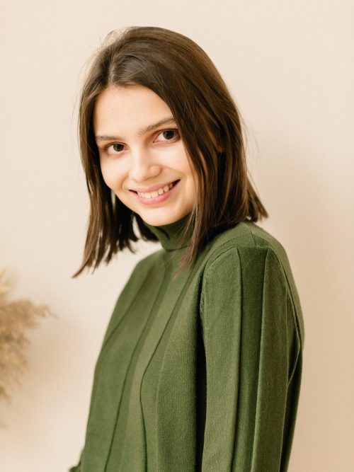 studio portrait of a young woman in sweater on beige background 1 1 e1654066249959