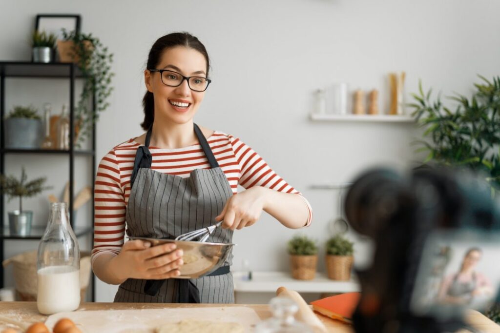 woman is recording vlog about cooking